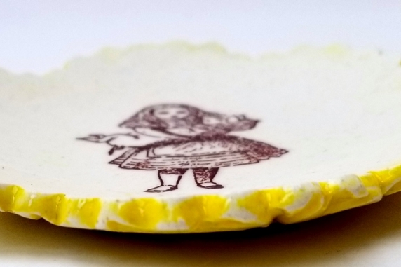 Tiny Plate Alice in Wonderland holding a pig!
