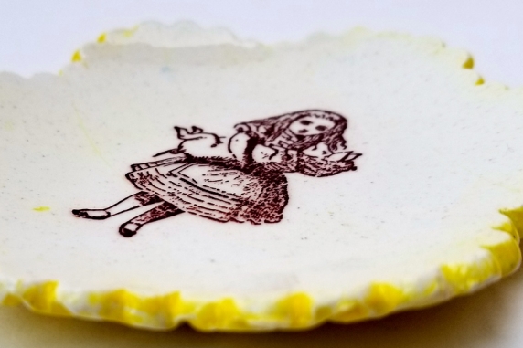 Tiny Plate Alice in Wonderland holding a pig!